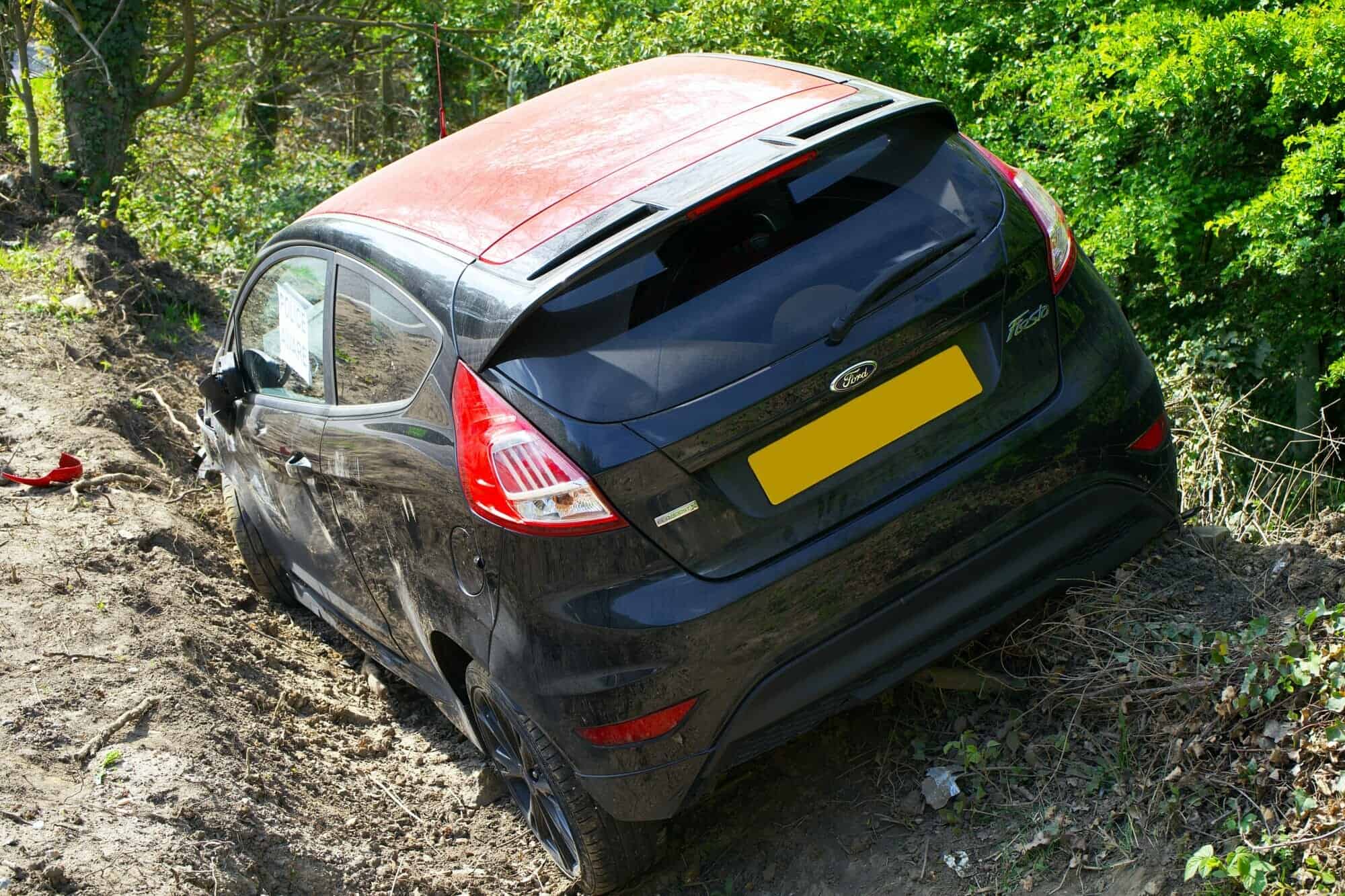 a black car in a ditch