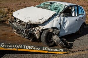 A car on the edge of a tow truck that has been in a head on collision car accident. Car accident lawyer concept