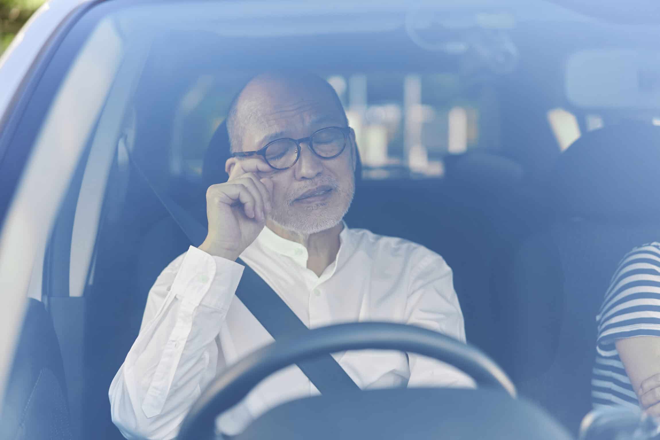 Elderly driver getting sleepy while driving