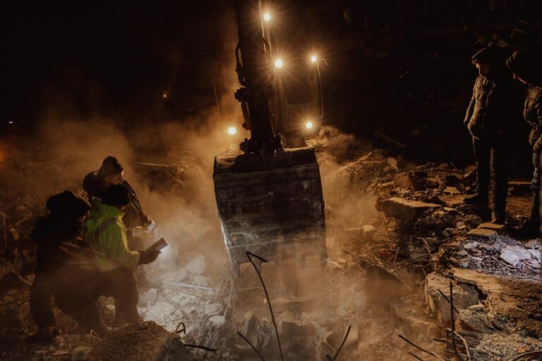 Construction workers working at night. Workers Compensation concept