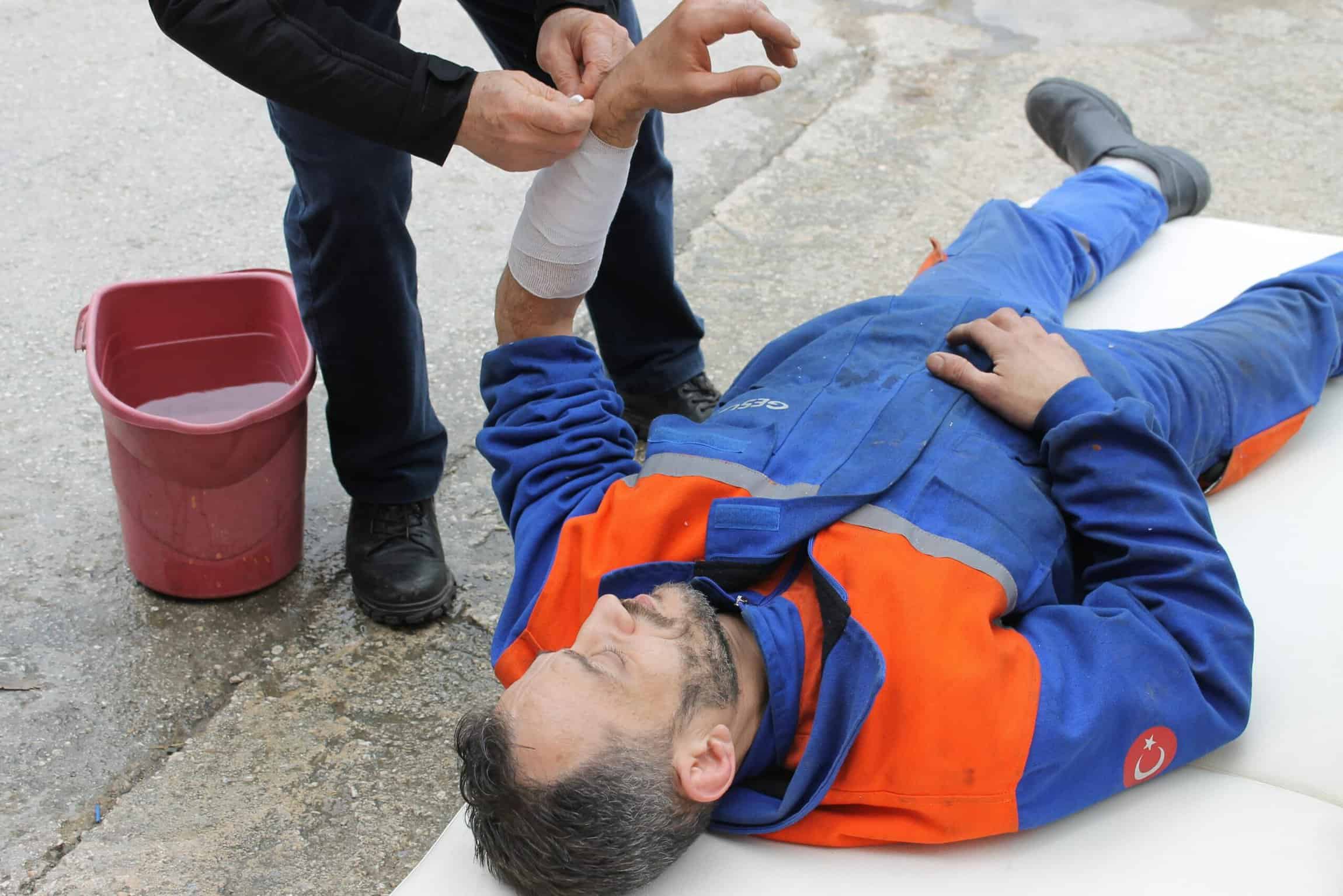 Man Lying on the Ground Receiving Medical Attention.