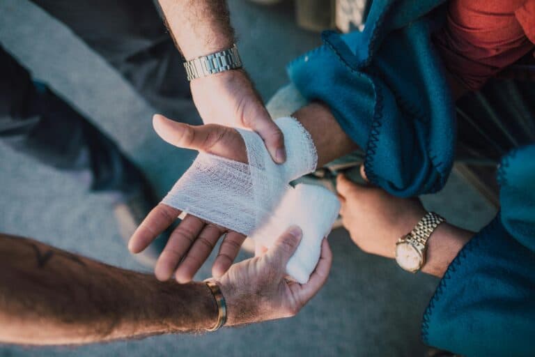 Someone Applying a Bandage to Another